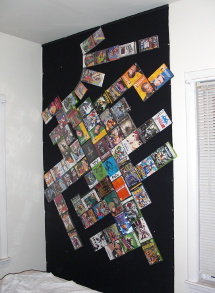 a wall covered in velcro with video games attached